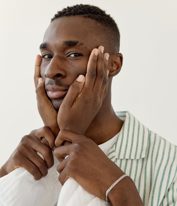 Man holding a difficult balance pose in a calm studio.